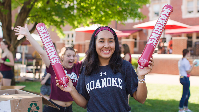 student with spirit sticks