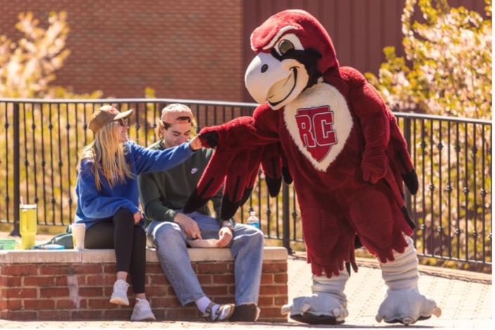 Student fist bumping Rooney