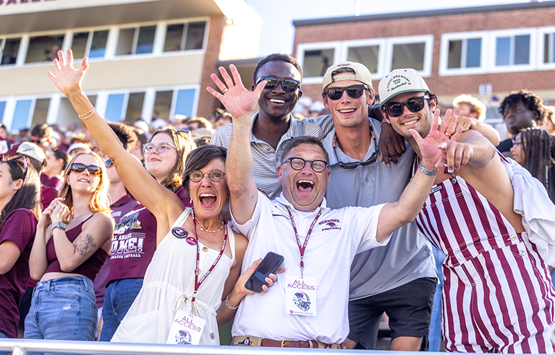 Kelly and Frank Shushok with students at first football game in 2024