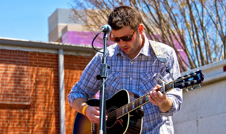 Image of a man playing a guitar