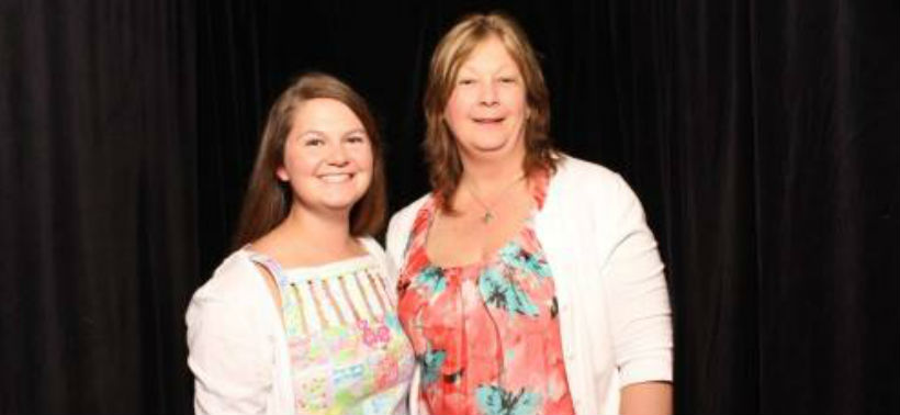 Two alumni pose for a picture together