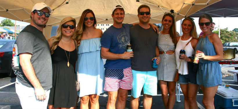 Eight alumni pose for a picture together outside