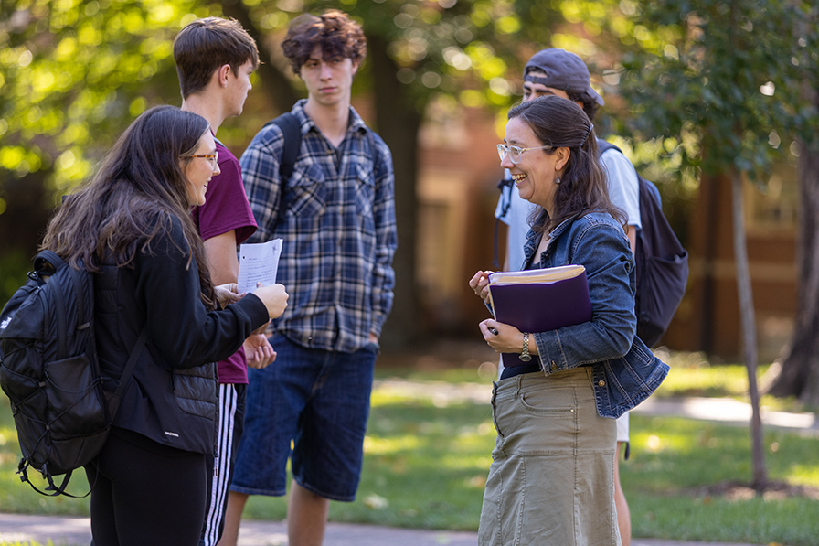 students talking to a professor