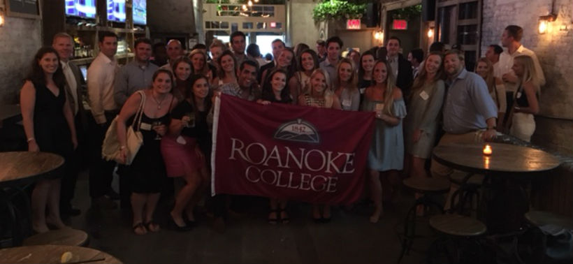 The New York Alumni chapter with the Roanoke College flag at a social event