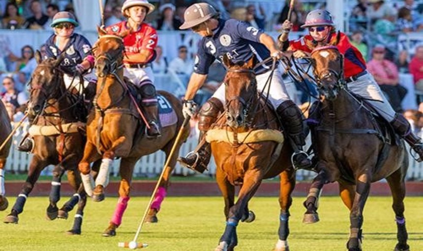 People riding horses playing polo