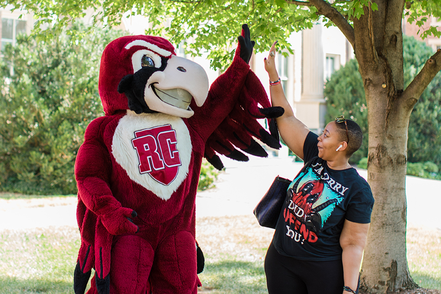 A student high fives Rooney