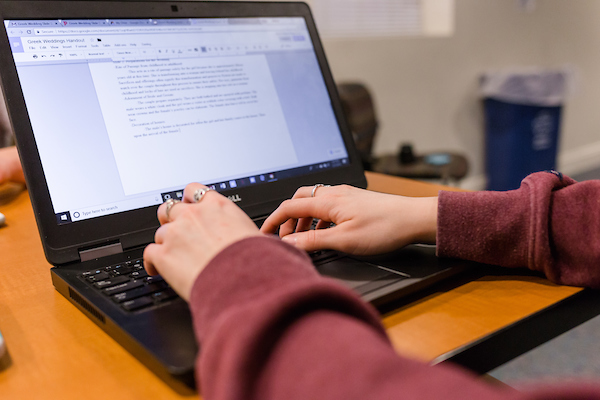 A person typing on a laptop