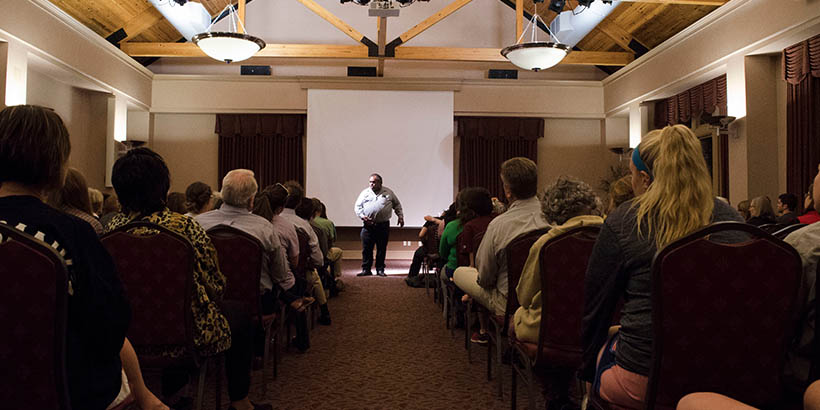 Students at a black history month event listening to a speaker