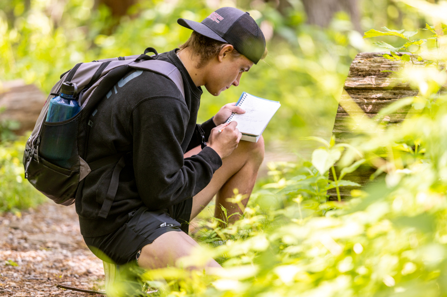 student outside writing