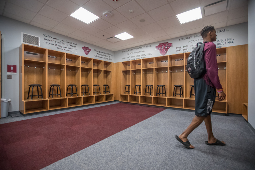 A student walking in the Cregger Center mens' locker room