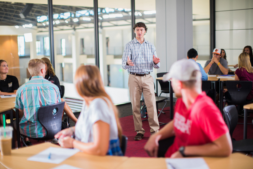 Students looking at a peer doing a presentation