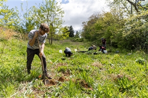 student digging a hole