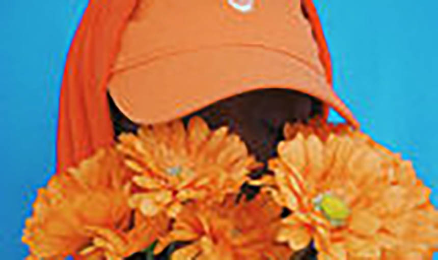 a man in an orange hat wearing an orange sweatshirt and holding orange flowers