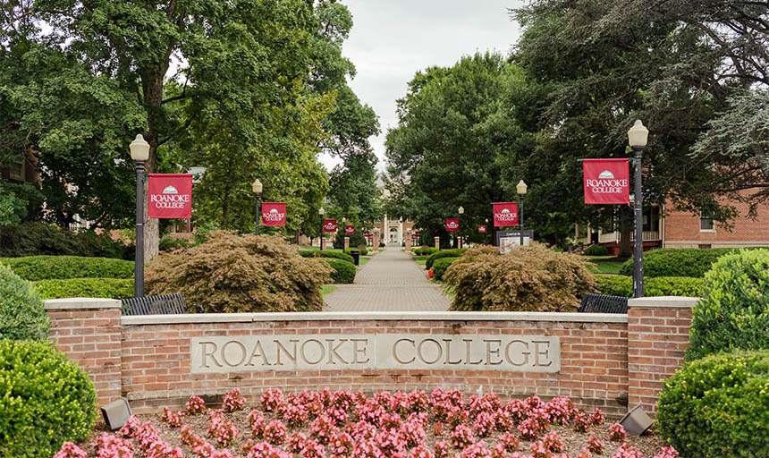The large Roanoke College sign and campus around it