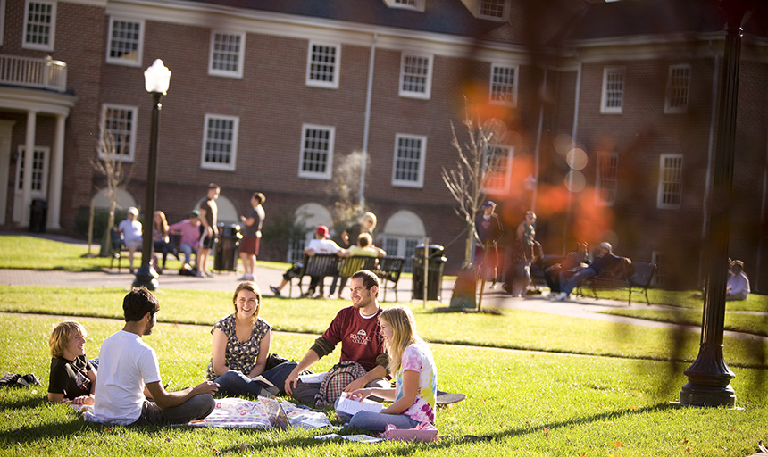 students sitting on the grass