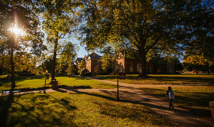 A student walking through the Front Quad