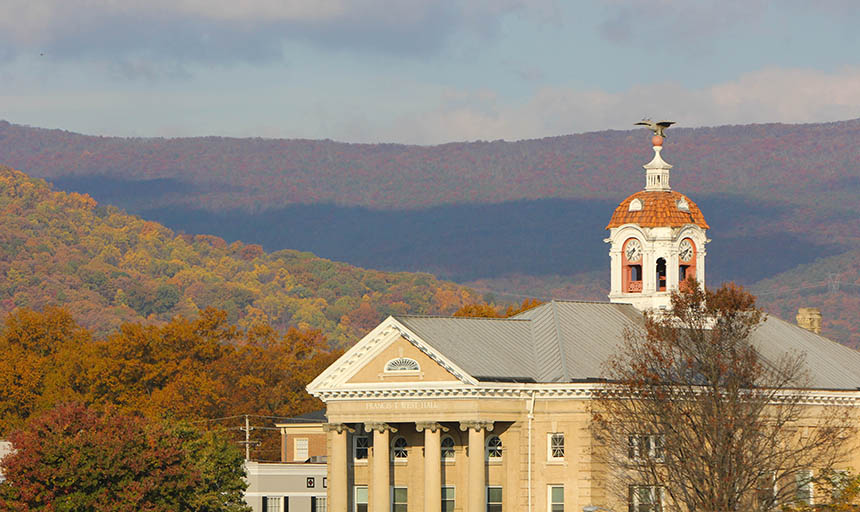 The top of West Hall with the mountains in the background