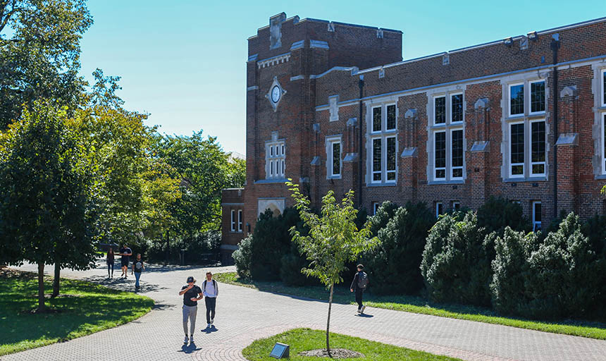 students walking past alumni gym