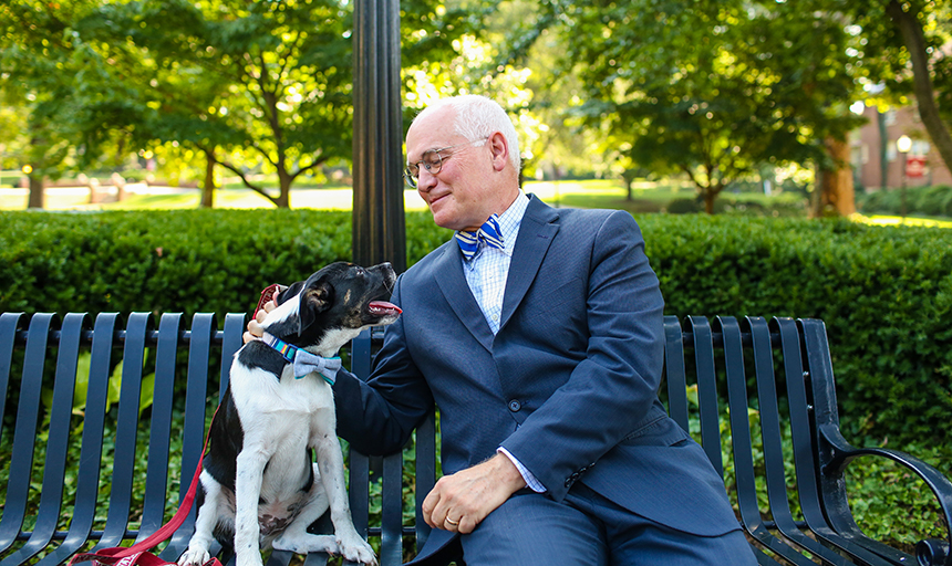President Maxey and Dog wearing bowties on bench