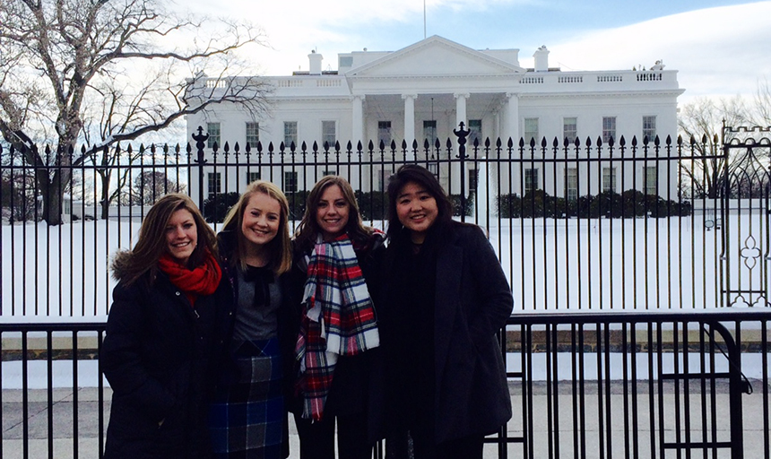 Female students standing in front of the White House