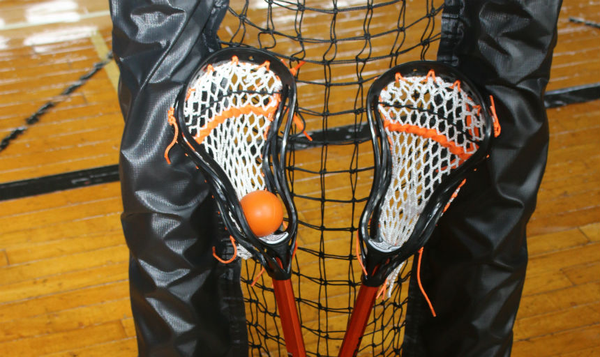lacrosse sticks up against a net
