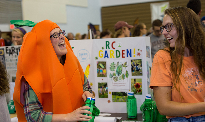 Activities Fair student in a carrot suit laughing