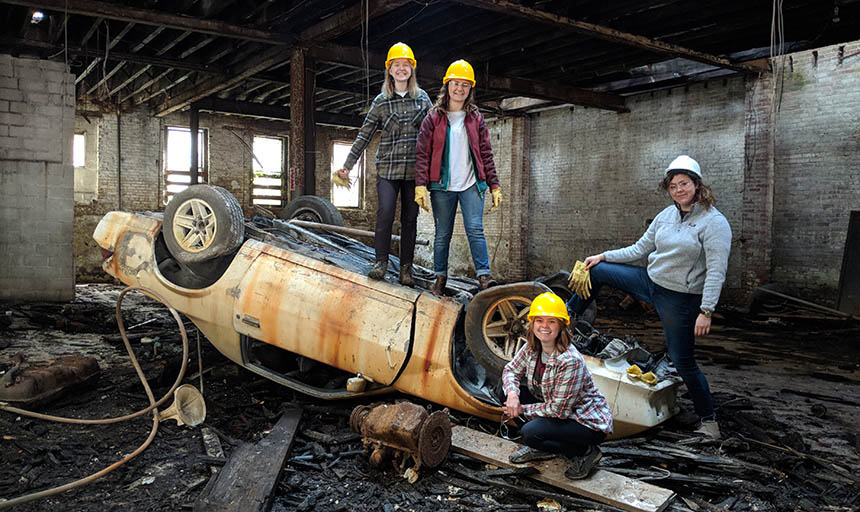 Group of students standing by a house being built