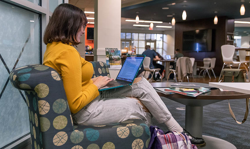 A student writing in the library