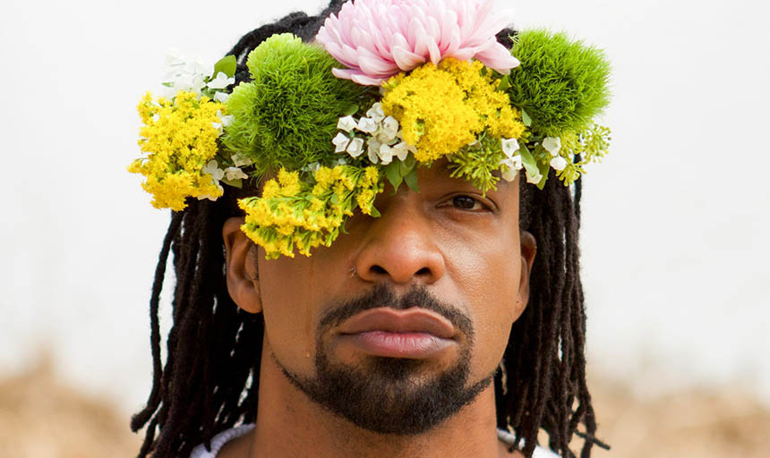 Jericho Brown wearing a white t-shirt and a flower crown