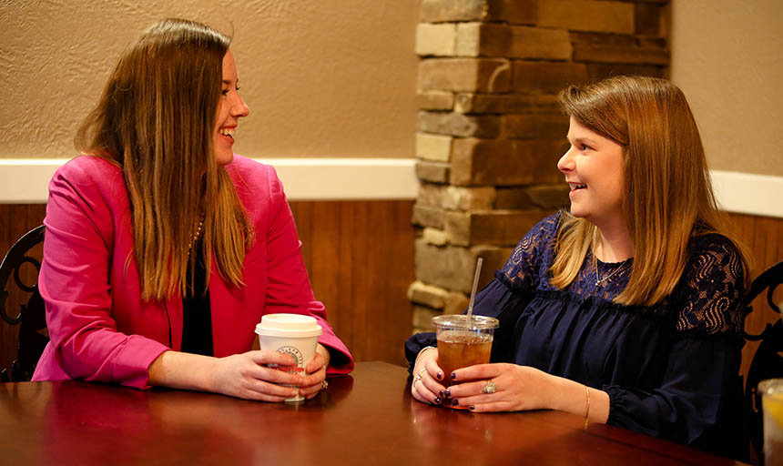 A student and their mentor chatting over coffee