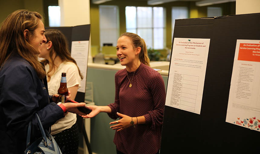 A student talking to another about her research