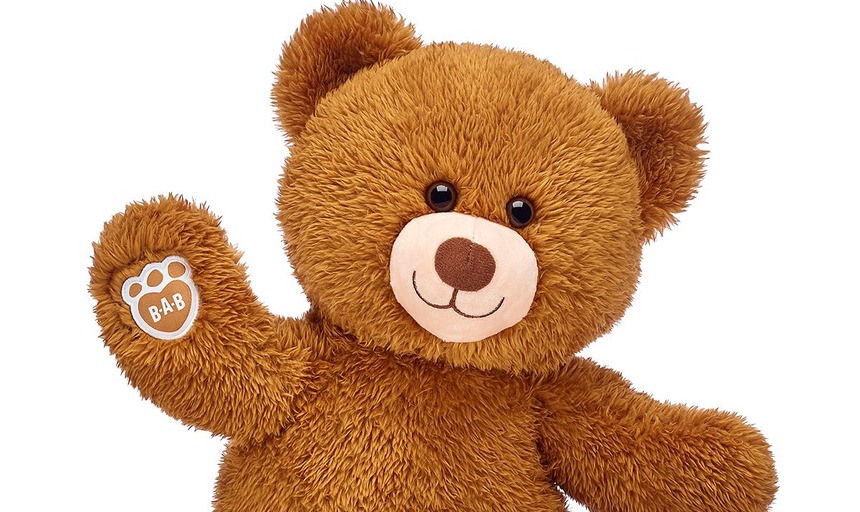 A build-a-bear stuffed animal with one paw raised