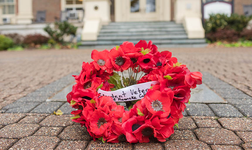 A wreath from the Roanoke College Student Veterans' Group laying in front of the administration building