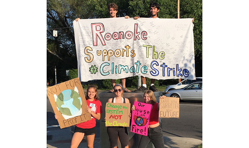 students holding Climate Justice posters