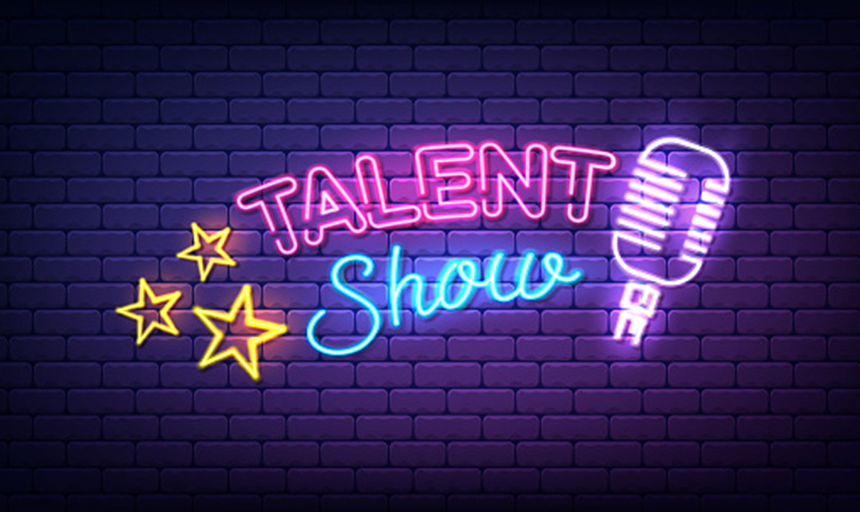 A neon sign that reads "Talent Show" with neon stars on one side and a microphone on the other