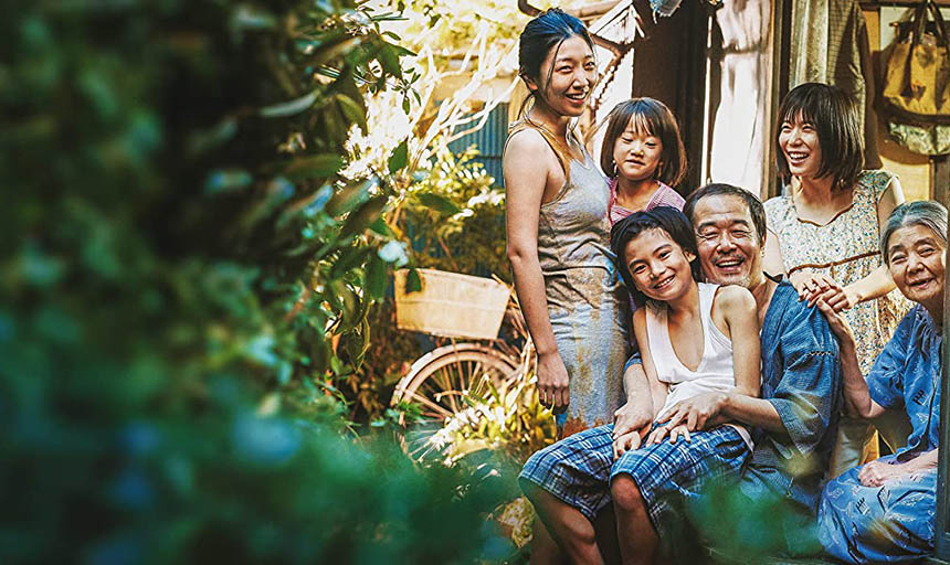 A Japanese family smiling together: three women, a man, and two children