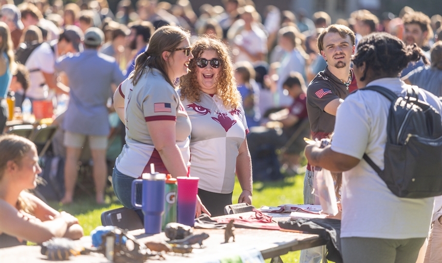rugby club students talking with other students