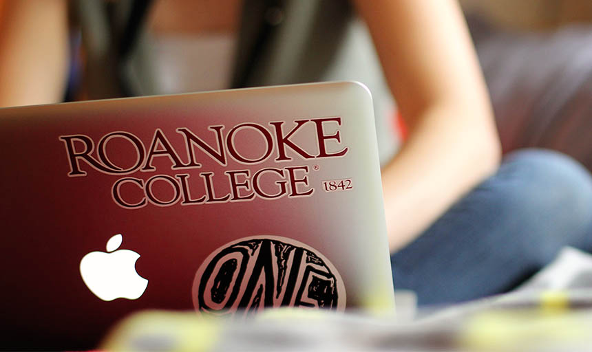 back of a laptop with Roanoke College Sticker on it