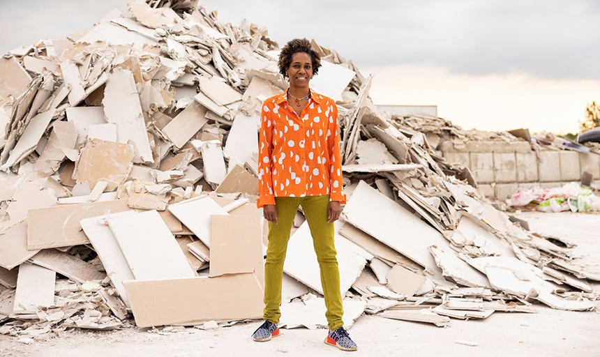 Karyn Olivier stands in front of a pile of material