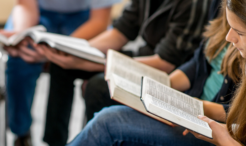 people holding bibles during a study session