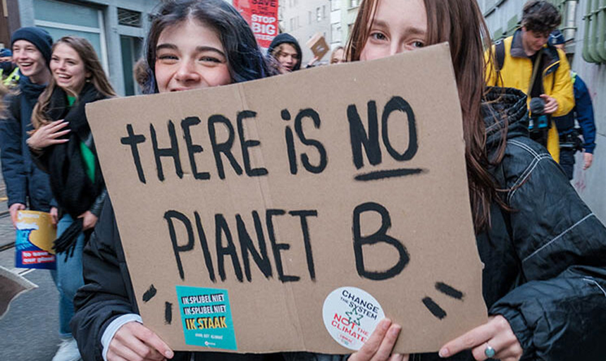 protesters holding a sign "there is no planet B"