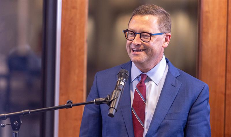 President Frank Shushok speaking into a microphone