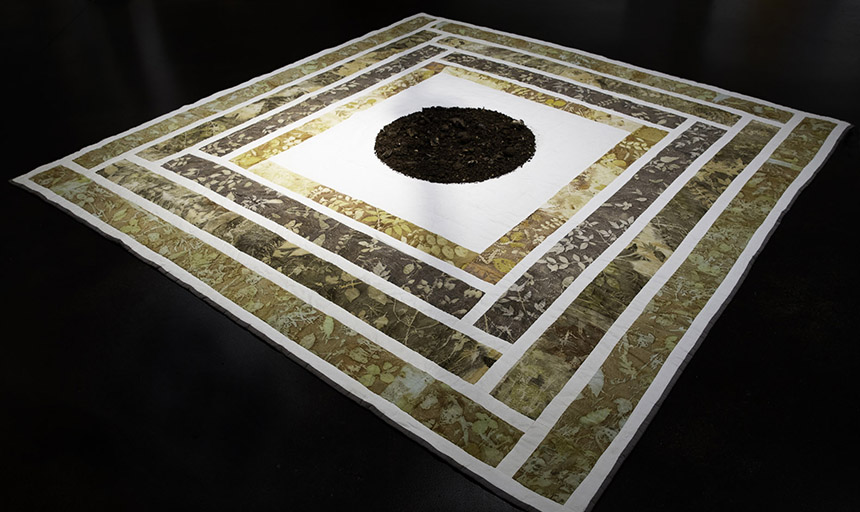 Pile of compost on a large quilt with floral patterns
