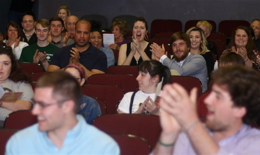 Audience cheering from theater seats