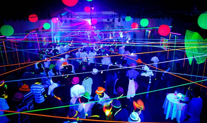 neon party with lights and people in glowing costumes