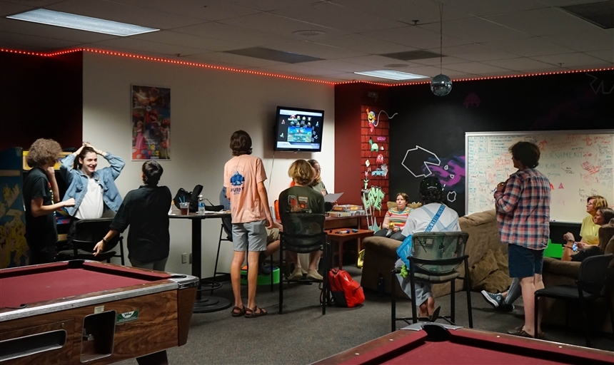 students playing Mario Kart in the gameroom