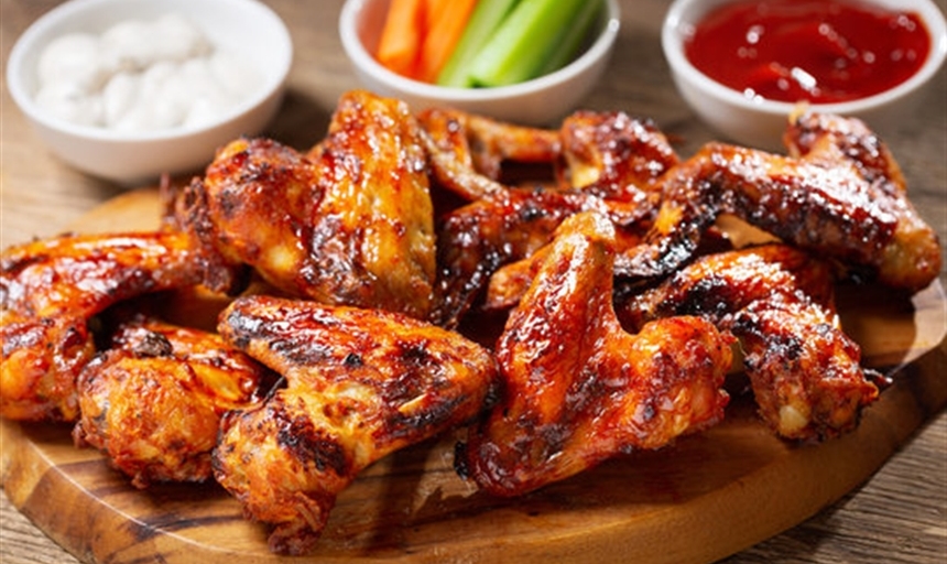 chicken wings on a table with sides