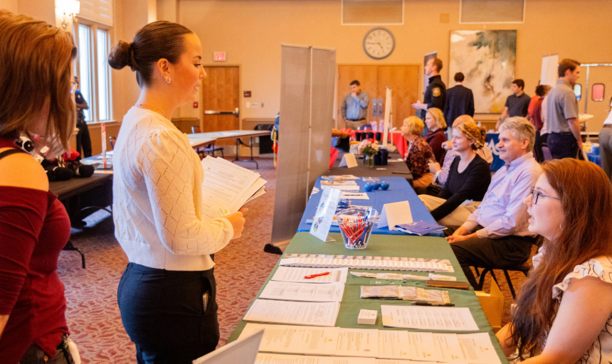 Students talking with representatives at a career fair