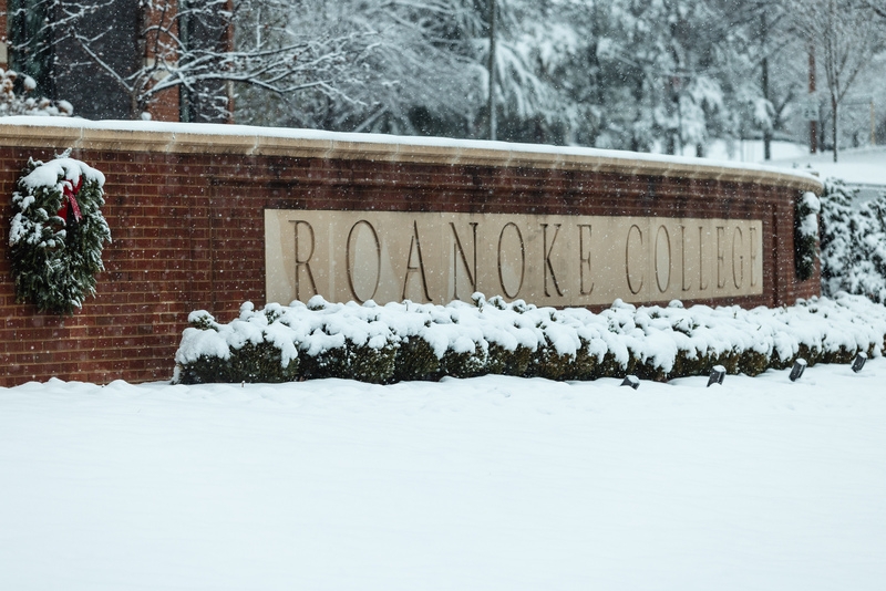 Roanoke College sign with snow and wreath