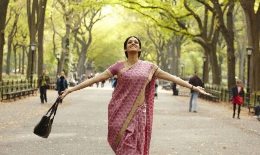 A woman smiling with her arms outstretched